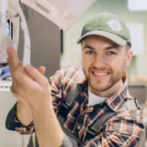 Technician inspecting AeroChill air conditioning unit components.